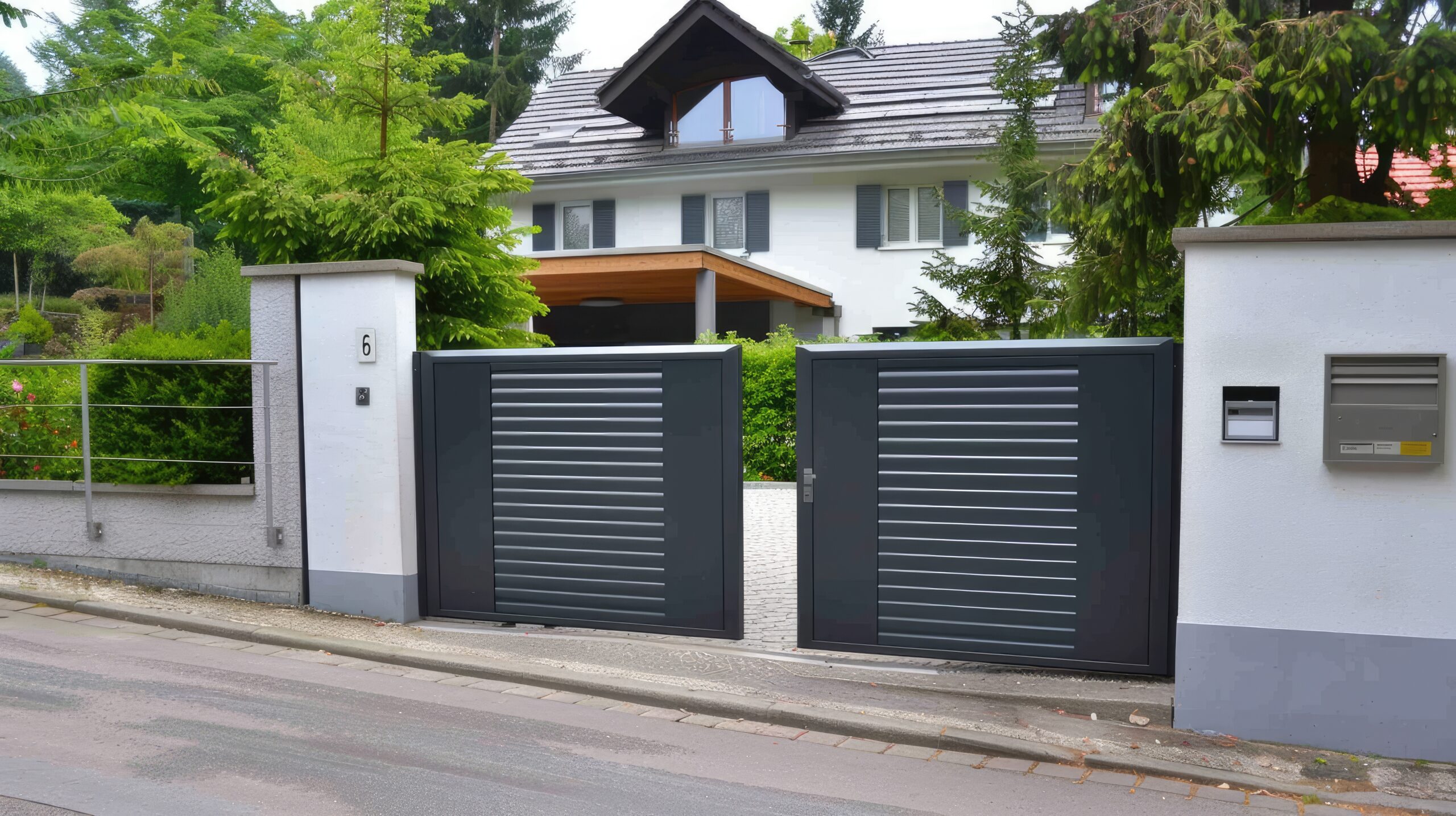 A modern, two-door aluminum gate with silver stripes, an intercom system, and a paved driveway.